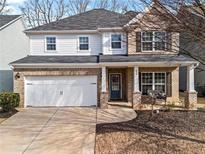 Charming two-story home with a two-car garage and landscaped front yard at 455 Timberleaf Rd, Canton, GA 30115