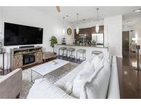 Bright living room features hardwood floors, modern furnishings and an open-concept layout to the kitchen at 200 N Highland Ne Ave # 207, Atlanta, GA 30307
