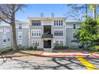 A charming exterior view of a modern two-story apartment complex surrounded by lush greenery and blue skies at 516 Summit North Ne Dr, Atlanta, GA 30324