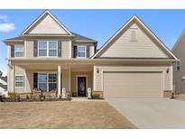Inviting two-story home featuring a covered porch, neutral siding, and an attached two-car garage at 250 Riverclub Rd, Acworth, GA 30101