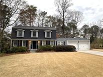 Charming two-story home with a well-maintained front yard and a two-car garage at 2426 Glenbonnie Dr, Atlanta, GA 30360