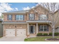 Charming two-story brick home with a two-car garage and manicured front lawn at 920 Sublime Trl, Canton, GA 30114