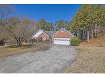 Charming single Gathering home with a two-car garage and a well maintained lawn at 2214 Fort Martin Way, Lawrenceville, GA 30045