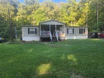 Charming home featuring a covered front porch and set on a spacious, well-manicured lawn at 340 Pat Rich, Canton, GA 30115