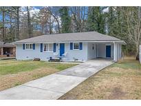 Charming single-story home featuring a long driveway and blue accents at 470 Oriole Dr, Marietta, GA 30067