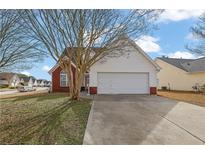 Charming single Gathering home with an attached garage and well-manicured lawn at 2612 Kirkhill Ct, Lawrenceville, GA 30044