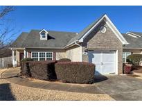 Charming single-Gathering home showcasing a well-manicured lawn and attached garage at 905 City Park Dr, Mcdonough, GA 30252