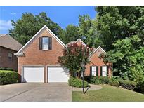 Charming brick home with a two-car garage and mature landscaping at 1337 Parkview Ln, Kennesaw, GA 30152
