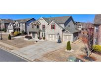 Traditional two-story brick home with attached two-car garage and long driveway at 3488 In Bloom Way, Auburn, GA 30011
