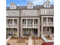 Charming brick townhomes featuring private balconies and covered front porches at 581 Brashy St, Woodstock, GA 30188