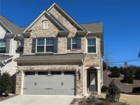 Beautiful two-story brick home with a two-car garage and well-maintained landscaping at 1643 Rose Bluff Way, Lawrenceville, GA 30043