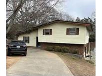 View of the home's exterior with siding and well-lit driveway at 2195 Wilson Nw Rd, Conyers, GA 30012