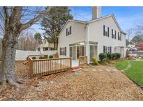 Well-maintained backyard with a spacious deck and sunroom attached to the home at 3815 Glen Laurel Ct, Cumming, GA 30040