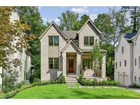 Charming two-story brick home with manicured lawn and inviting front entrance at 114 Terrace Ne Dr, Atlanta, GA 30305