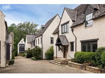 Charming row of townhomes features light-colored brick, and stylish architectural details at 20 Swann Wynd, Chattahoochee Hills, GA 30268