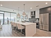 Modern kitchen with a large island, stainless steel appliances, and pendant lighting at 788 W Marietta Nw St # 913, Atlanta, GA 30318