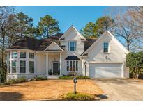 Charming brick home with a well-manicured lawn and attached two car garage at 1516 Ashford Club Ne Ct, Brookhaven, GA 30319