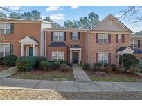 Charming brick townhome featuring a well-manicured lawn and inviting entrance at 3765 Town Square Cir # 5, Kennesaw, GA 30144