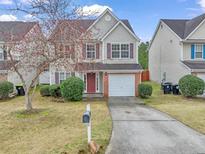 Charming two-story home with a well-maintained lawn, cozy curb appeal, and brick-accented garage at 6130 Hickory Lane Dr, Union City, GA 30291
