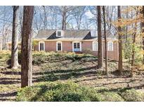 Charming brick home featuring a classic design and mature trees at 4095 Glen Devon Nw Dr, Atlanta, GA 30327