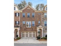 Charming brick townhome featuring a two-car garage and lovely architectural details at 4214 Perimeter E Park # 102, Chamblee, GA 30341