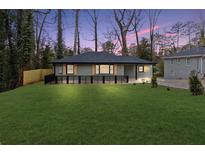 Charming home with a manicured lawn, black fence, and attractive shutters at 2863 Monterey Dr, Decatur, GA 30032