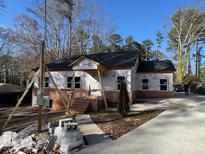 Exterior view of house with brick and siding construction under clear blue skies at 2515 Hogan Rd, East Point, GA 30344