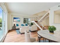 Inviting living room with wood floors, stylish furniture and a modern staircase at 587 Virginia Ne Ave # 315, Atlanta, GA 30306