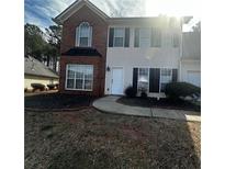 Charming two-story home features a brick and vinyl facade, well-maintained lawn, and inviting curb appeal at 12264 Crestwood Ct, Fayetteville, GA 30215