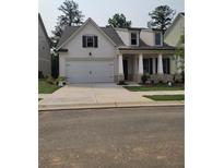 Charming home boasts a two-car garage, inviting porch, and neutral color scheme at 866 Lakemont Dr, Canton, GA 30114