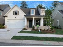 Charming one-story home with a two-car garage and manicured front yard with lovely lawn and beautiful landscaping at 866 Lakemont Dr, Canton, GA 30114