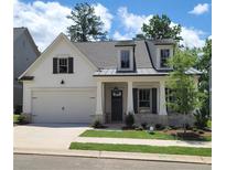 Charming craftsman-style home with a two-car garage and welcoming front porch at 866 Lakemont Dr, Canton, GA 30114