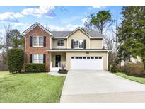 Charming two-story home featuring a mix of brick and siding, complete with a well-manicured lawn and inviting curb appeal at 3997 Riversong Ct, Suwanee, GA 30024