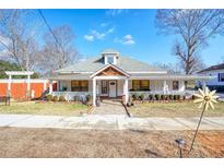 Charming single-story home featuring a welcoming front porch and well-manicured landscaping at 1724 Hill Ne St, Conyers, GA 30012