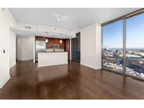 Open living room and kitchen with hardwood floors and expansive city views from floor-to-ceiling windows at 270 17Th Nw St # 2312, Atlanta, GA 30363
