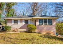 Charming one-story home with a brick facade, manicured lawn, and classic white-trimmed windows at 1255 North Nw Ave, Atlanta, GA 30318