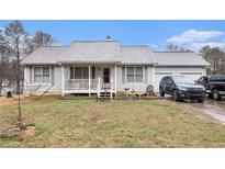 Charming single-story home with a welcoming front porch and attached two-car garage at 160 Wesley Chapel Rd, Villa Rica, GA 30180