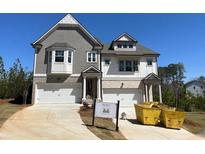 New two-story home with gray and white facade and two-car garage at 201 Retreat Ln, Canton, GA 30114