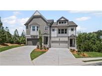 Charming new townhome features a brick and shingle exterior with well-manicured landscaping at 203 Retreat Ln, Canton, GA 30114