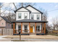 Charming two-story home with a welcoming front porch and a vibrant yellow door at 569 Hope Sw St, Atlanta, GA 30310