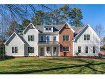Beautiful two-story home with a combination of siding and brick accents at 1601 Shadow Ct, Dunwoody, GA 30338