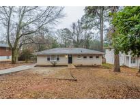 Charming single-story home with a brick facade and a well-maintained front yard at 3111 Flat Shoals Rd, Decatur, GA 30034