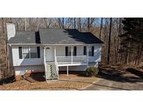 Charming single-Gathering home featuring a covered front porch and a well-maintained front yard at 1668 Independence Dr, Douglasville, GA 30134