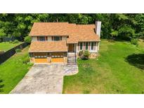 Charming two-story home with a two-car garage and a large, well-maintained yard at 4090 Welcome All Ter, Atlanta, GA 30349