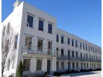 Stunning white painted brick townhome featuring large windows and balconies on multiple floors at 304 Stonemont Dr, Atlanta, GA 30305