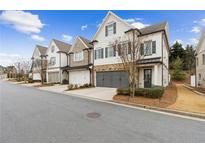 Charming townhomes with a modern architectural style and well-maintained landscaping at 569 Stone Field Nw Run, Marietta, GA 30060