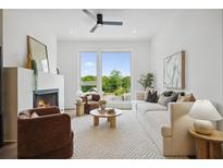 Bright living room with fireplace, ceiling fan, and large windows offering lots of natural light at 1570 Flat Shoals Se Rd # 7, Atlanta, GA 30316