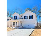 Charming two-story white farmhouse featuring a two car garage and welcoming front porch at 2371 Brown Dove Way Lot 4, Grayson, GA 30017