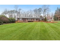 Charming single-story home with a large, well-manicured front yard and mature trees at 3154 Chamblee Tucker Rd, Atlanta, GA 30341