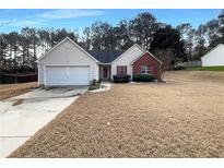 Charming single-Gathering home with a well-manicured lawn and attached two-car garage at 3151 Victoria Place Dr, Loganville, GA 30052